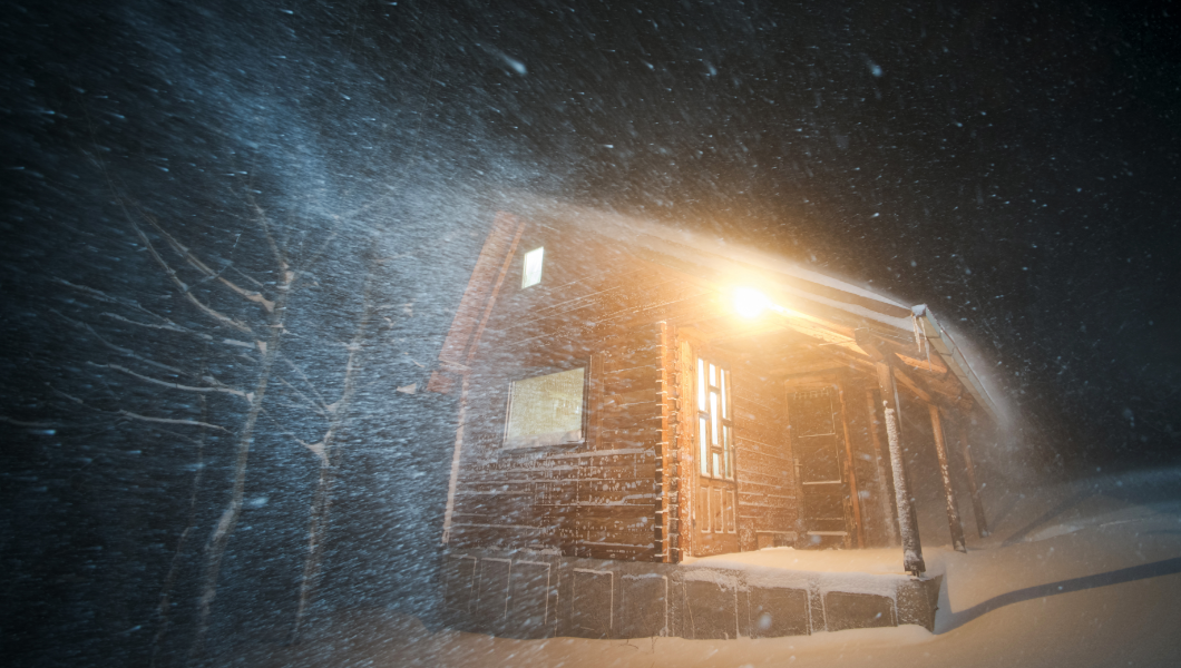 rural cabin lit by reliable Guzman Energy electricity during snowstorm